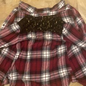 This is a beautiful button down plaid shirt on the back it has black lace